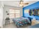 Bedroom featuring vibrant blue accent wall, fan, closet rod, and large window with wood blinds at 1510 S De Gaulle Cir, Aurora, CO 80018
