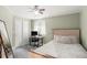 Bedroom with a light green accent wall, closet, and natural light from a window at 1510 S De Gaulle Cir, Aurora, CO 80018