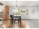 Bright dining area featuring a breakfast bar with seating and views of the surrounding landscape at 1510 S De Gaulle Cir, Aurora, CO 80018