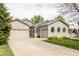 Attractive home featuring a well-manicured lawn, attached garage and long driveway at 1510 S De Gaulle Cir, Aurora, CO 80018