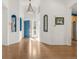 Bright foyer with hardwood floors, high ceilings, and a vibrant blue front door at 1510 S De Gaulle Cir, Aurora, CO 80018