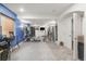 Home gym in basement featuring blue accent wall, weight machines, and bright lighting at 1510 S De Gaulle Cir, Aurora, CO 80018