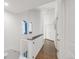 Upstairs hallway featuring hardwood floors, white walls, and unique architectural details at 1510 S De Gaulle Cir, Aurora, CO 80018