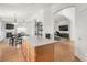 Open kitchen with central island flowing into living and dining areas at 1510 S De Gaulle Cir, Aurora, CO 80018