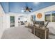 Basement living room with blue ceiling, desk area, ceiling fan, and comfortable seating at 1510 S De Gaulle Cir, Aurora, CO 80018