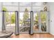 Bright sun room featuring hardwood floors and large windows overlooking the spacious outdoor area at 1510 S De Gaulle Cir, Aurora, CO 80018