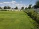 Large backyard with a green lawn and a fence creating a private outdoor space at 2208 Champlain Dr, Boulder, CO 80301
