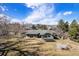 Lush backyard featuring a patio, mature trees, and mountain views at 2208 Champlain Dr, Boulder, CO 80301