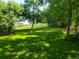 Expansive backyard featuring lush lawn and mature trees offering shade and privacy at 2208 Champlain Dr, Boulder, CO 80301