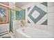 Bathroom featuring tub, shower, and uniquely tiled walls at 2208 Champlain Dr, Boulder, CO 80301