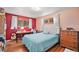 Bedroom features hardwood floors, two windows, and a guitar at 2208 Champlain Dr, Boulder, CO 80301