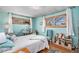 Cozy bedroom with calming light blue walls, hardwood floors, and natural light streaming through the windows at 2208 Champlain Dr, Boulder, CO 80301