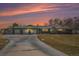 Charming home with a three-car garage and long driveway, set against a vivid sunset at 2208 Champlain Dr, Boulder, CO 80301