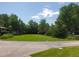 Well-maintained front yard featuring a green lawn and mature trees, enhancing curb appeal at 2208 Champlain Dr, Boulder, CO 80301