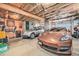 Spacious garage with two parked cars and overhead storage, ideal for vehicle and item storage at 2208 Champlain Dr, Boulder, CO 80301