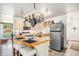 Kitchen with tile flooring, island with seating, and hanging pot rack at 2208 Champlain Dr, Boulder, CO 80301