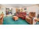 Cozy living room featuring a green carpet, sofa, and access to the kitchen at 2208 Champlain Dr, Boulder, CO 80301