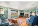 Inviting living room with a fireplace, wood floors, and a large window at 2208 Champlain Dr, Boulder, CO 80301