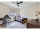 Comfortable bedroom featuring a cozy bed, functional desk, and natural light from the window at 3261 S Sherman St, Englewood, CO 80113
