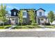 A row of modern townhomes with black and white exteriors and lush green lawns, offering a stylish curb appeal at 3261 S Sherman St, Englewood, CO 80113