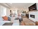 Open-concept living room featuring a fireplace, comfortable seating, and seamless transition to the dining area at 3261 S Sherman St, Englewood, CO 80113