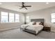 Bright main bedroom with large windows, a ceiling fan, and a comfortable bed, creating a serene retreat at 3261 S Sherman St, Englewood, CO 80113