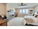Spacious main bedroom featuring a cozy fireplace, expansive window, and neutral decor at 3261 S Sherman St, Englewood, CO 80113