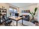 Home office featuring a modern desk, cozy sofa, and natural light from a large window at 3261 S Sherman St, Englewood, CO 80113
