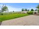A large, grassy yard with a patio, surrounded by a white picket fence at 6185 Saddle Bow Ave, Parker, CO 80134