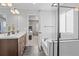 Bathroom featuring double vanity sinks, a soaking tub, and a glass-enclosed shower, offering a luxurious feel at 6185 Saddle Bow Ave, Parker, CO 80134