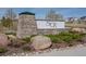 Stone community entrance sign surrounded by landscaping and shrubbery at 6185 Saddle Bow Ave, Parker, CO 80134
