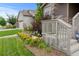 A landscaped front yard is shown, with flowerbeds flanking the porch steps at 6185 Saddle Bow Ave, Parker, CO 80134