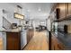 Modern kitchen featuring an island with bar seating, stainless steel appliances, and hardwood floors at 6185 Saddle Bow Ave, Parker, CO 80134