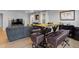 Inviting living room featuring stylish seating, a dining table with stools, and hardwood floors at 6185 Saddle Bow Ave, Parker, CO 80134