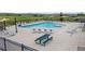 Community pool with lounge chairs, tables, and picnic area for residents' enjoyment at 6185 Saddle Bow Ave, Parker, CO 80134