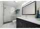 Modern bathroom featuring a glass-enclosed shower with tile surround and sleek vanity with quartz countertop at 4235 Lark Sparrow St, Highlands Ranch, CO 80126
