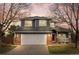 Charming two-story home featuring a brick facade, a two-car garage, and a cozy front porch at 4235 Lark Sparrow St, Highlands Ranch, CO 80126