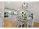 Open-concept kitchen with white cabinetry, stainless appliances, and an adjacent dining area at 4235 Lark Sparrow St, Highlands Ranch, CO 80126