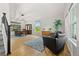 Bright living room with hardwood floors, dining area, and comfortable seating at 4235 Lark Sparrow St, Highlands Ranch, CO 80126