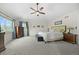 Bright and spacious main bedroom with a large window, soft carpet, and elegant furnishings at 4235 Lark Sparrow St, Highlands Ranch, CO 80126