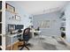 Well-lit home office with built-in shelving, modern desks, and a comfortable workspace at 4235 Lark Sparrow St, Highlands Ranch, CO 80126