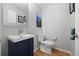 Stylish powder room with modern fixtures, wood floors, and decorative artwork on the wall at 4235 Lark Sparrow St, Highlands Ranch, CO 80126