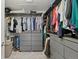 Spacious walk-in closet with custom gray shelving and ample storage for clothing at 4235 Lark Sparrow St, Highlands Ranch, CO 80126