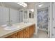 Updated bathroom with a double vanity, mirrors and a shower at 4961 Aspen Creek Dr, Broomfield, CO 80023