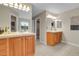 Bathroom with double sinks, wooden cabinetry, tile floors, and a well-lit vanity area at 4961 Aspen Creek Dr, Broomfield, CO 80023