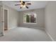 Neutral bedroom featuring plush carpet, and a large window with views of mature trees at 4961 Aspen Creek Dr, Broomfield, CO 80023