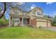 Lovely home with a covered front porch, lush lawn, and a convenient three-car garage at 4961 Aspen Creek Dr, Broomfield, CO 80023
