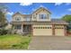 Charming two-story home features a well-manicured lawn and a convenient three-car garage at 4961 Aspen Creek Dr, Broomfield, CO 80023
