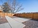 Concrete slab in backyard with wooden fence and gate at 17990 E Cornell Dr, Aurora, CO 80013