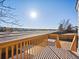 A wooden deck overlooks the backyard with scenic views under a bright, sunny sky at 17990 E Cornell Dr, Aurora, CO 80013